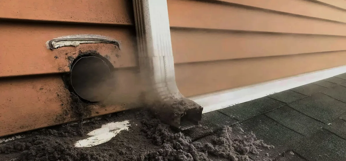 Attica Air Duct Cleaners technician cleaning a dryer vent to prevent fire hazards in an Orlando home